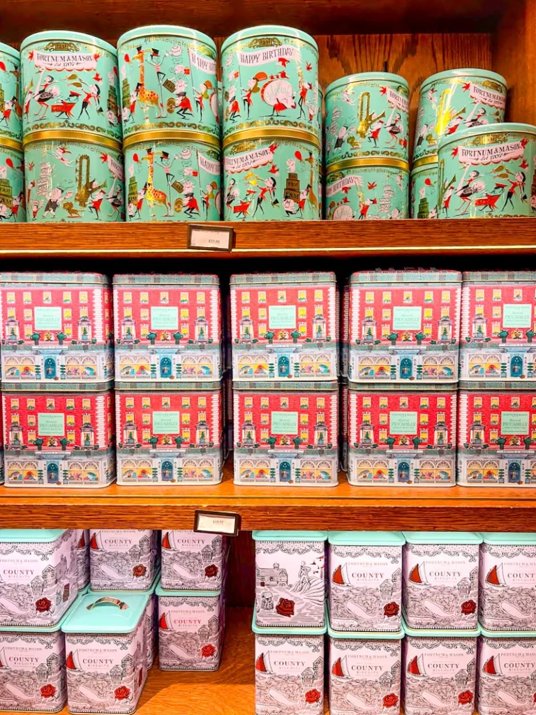 colorful tins of biscuits stacked on the shelves at fortnum and mason tea house in london
