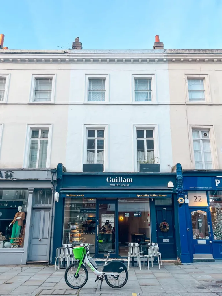 navy blue facade of guillam coffee shop in kensington, london