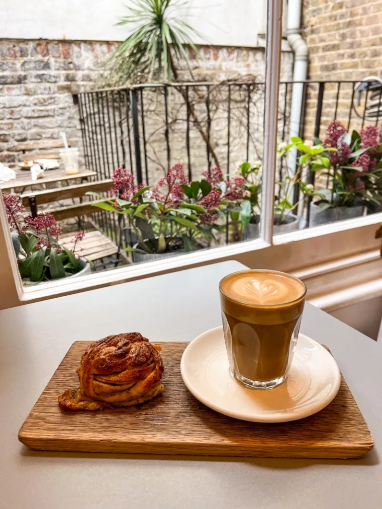 latte and a cardamom bun at hjem coffee shop in kensington, london