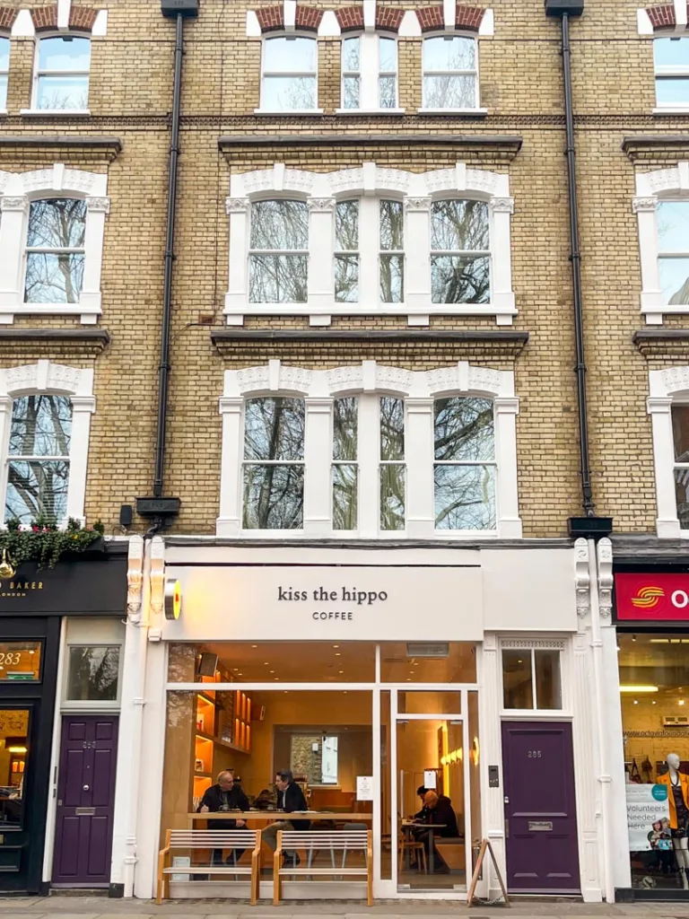 white facade of kiss the hippo coffee shop in london