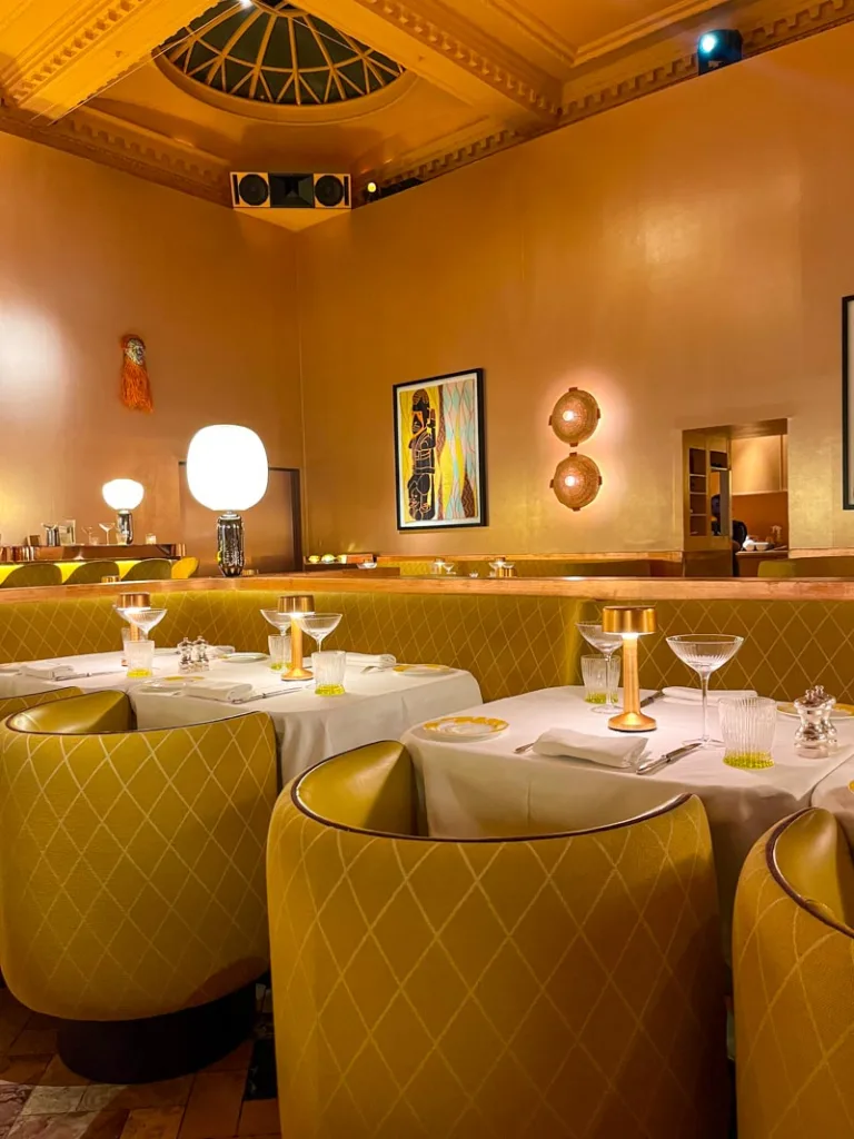 baby pink decor, and mustard yellow arm chairs at sketch tea room in london