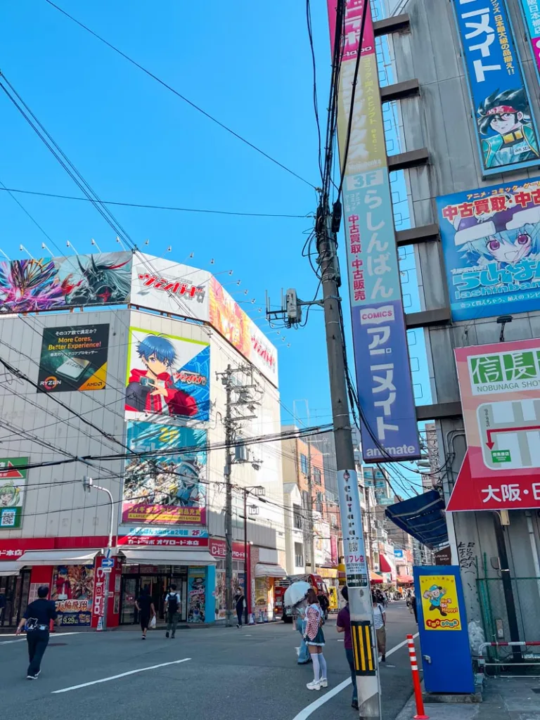 street with anime billboards in nipponbashi denden town in osaka