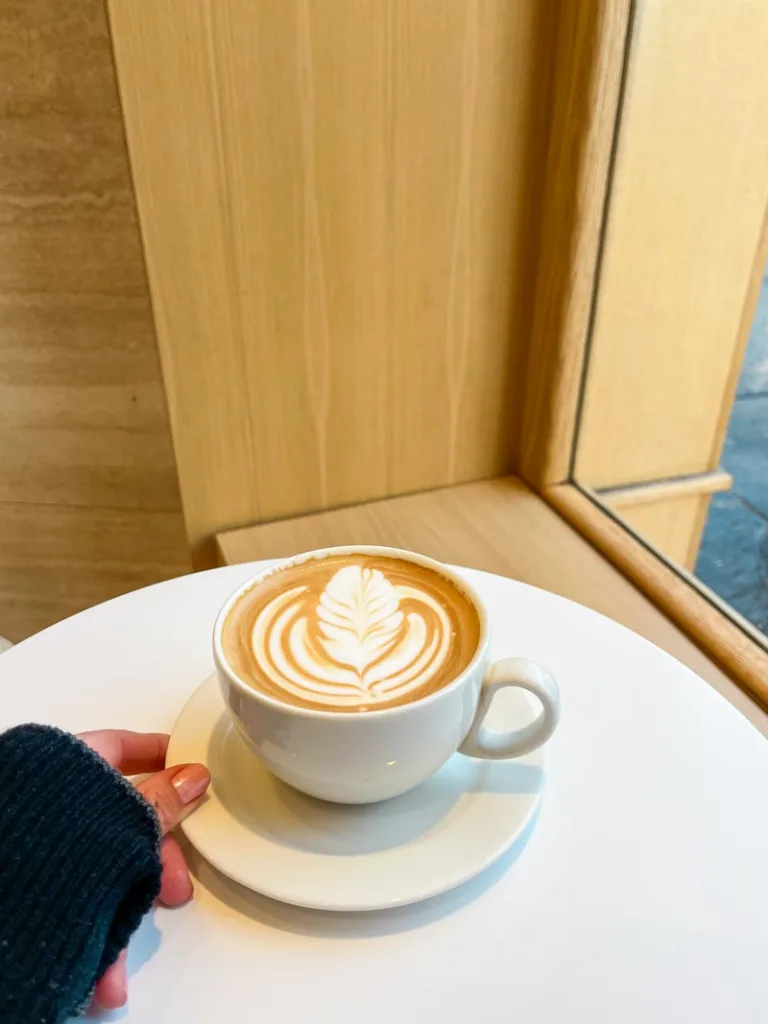 a kyoto latte on a white ceramic mug at %arabica coffee shop in paris