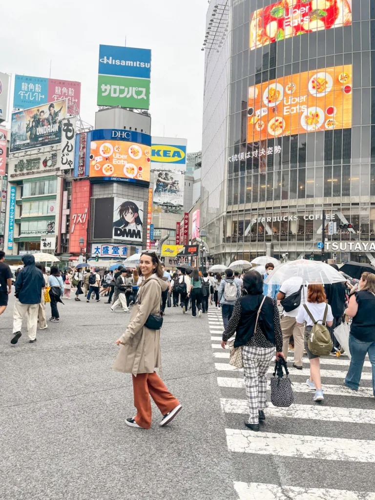 woman standing in the middle of Shibuya crossing in Tokyo