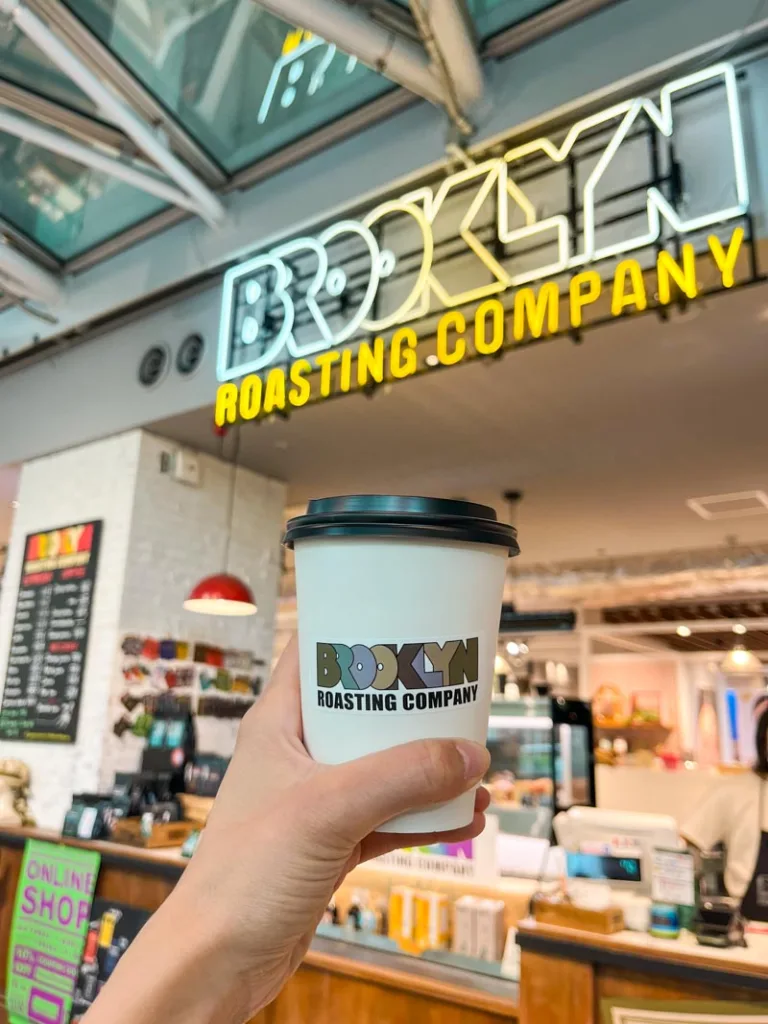 Hand holding a to go coffee cup at Tokyo station