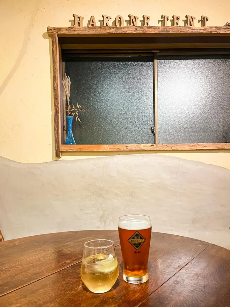 two drinks on a table at the bar area at guesthouse hakone tent