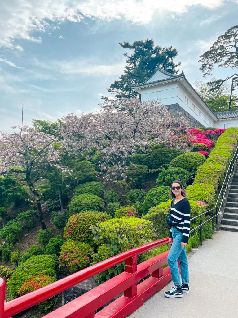 Woman standing in front of the vibrant gardens at Odawara castle