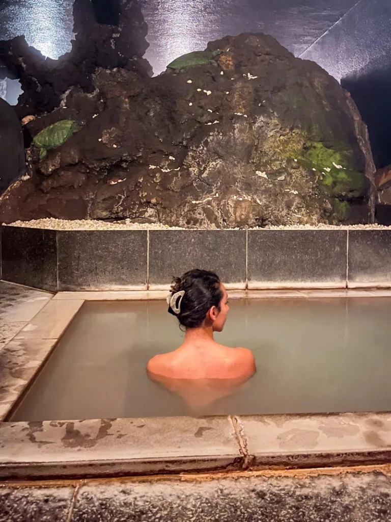woman inside a private onsen bath in guesthouse hakone tent 