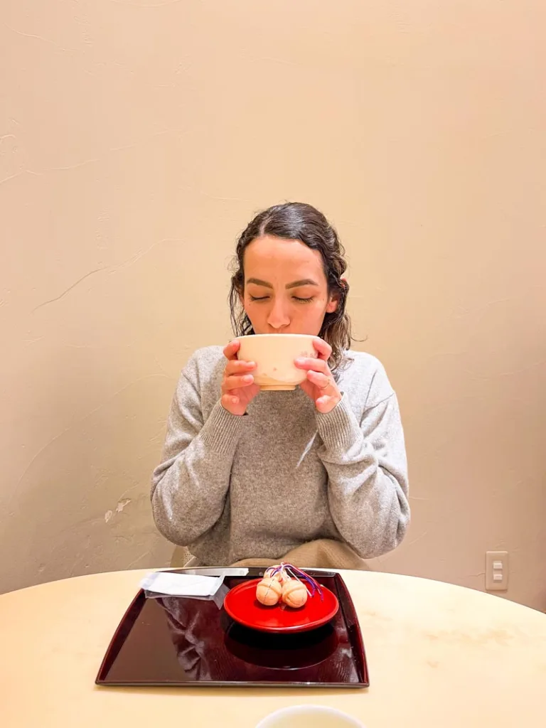 woman sipping from a matcha bowl
