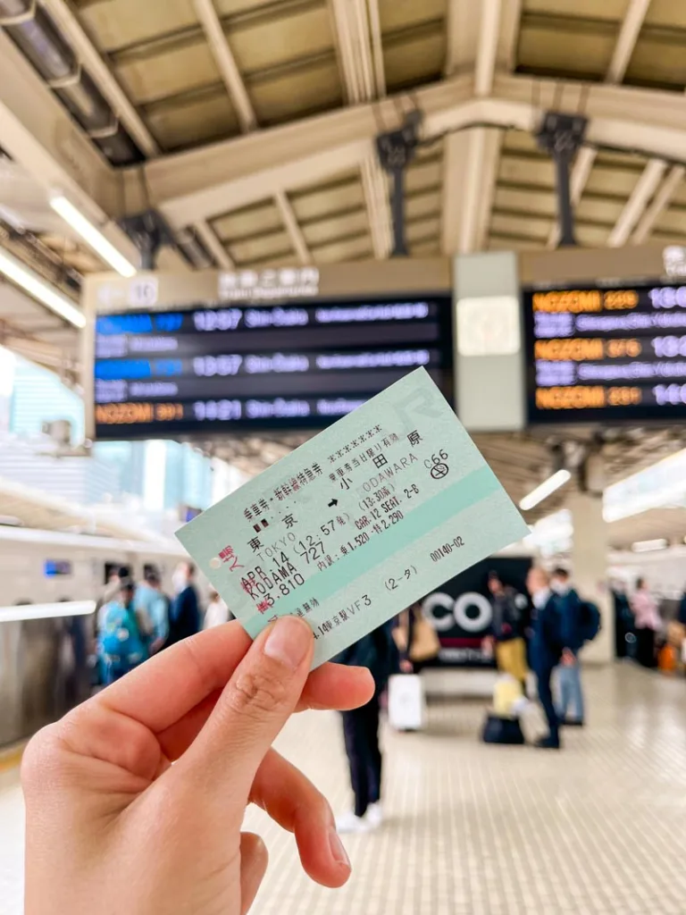 Hand holding a train ticket o Odawara