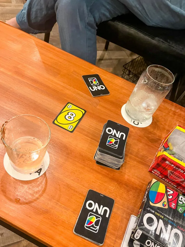 Uno cards and empty cocktail glasses at Cafe LA in Osaka