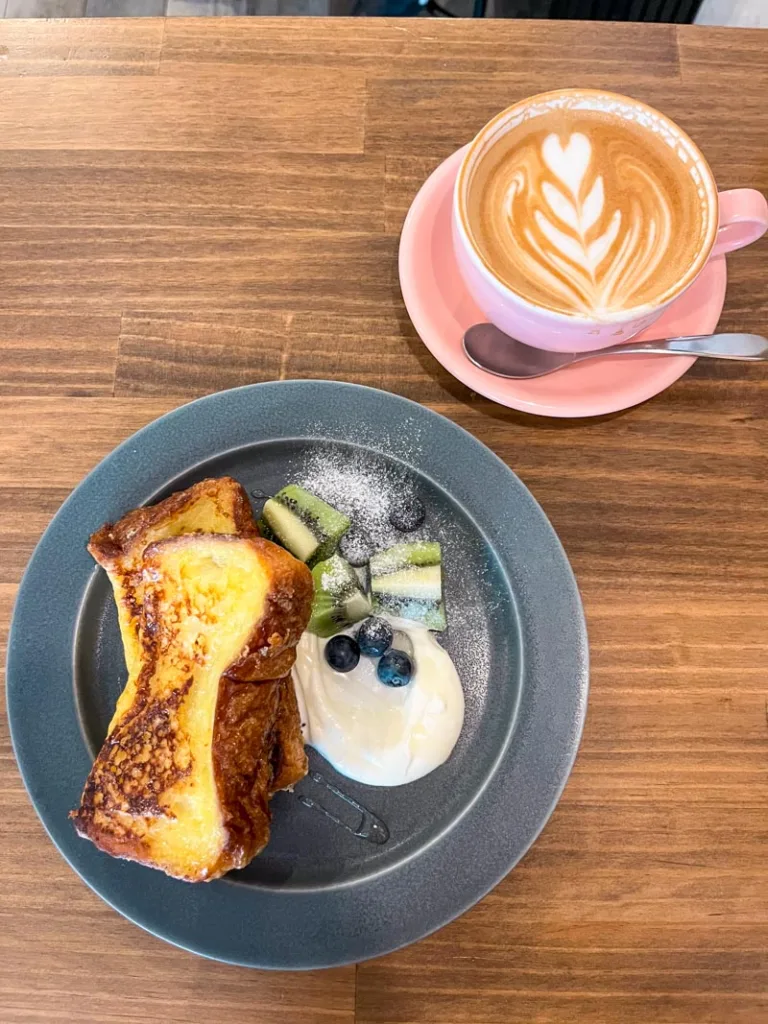 Sweet french toast and a latte at a table in cafe tales in osaka