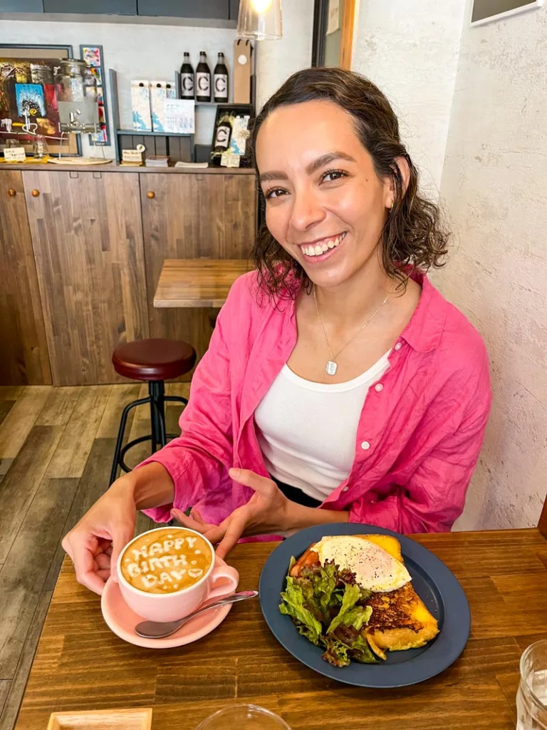 Woman with a latte and french toast at cafe tales in Osaka