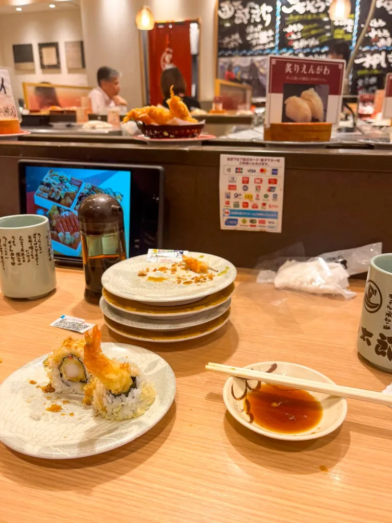 sushi plates at a conveyor belt sushi restaurant in Osaka