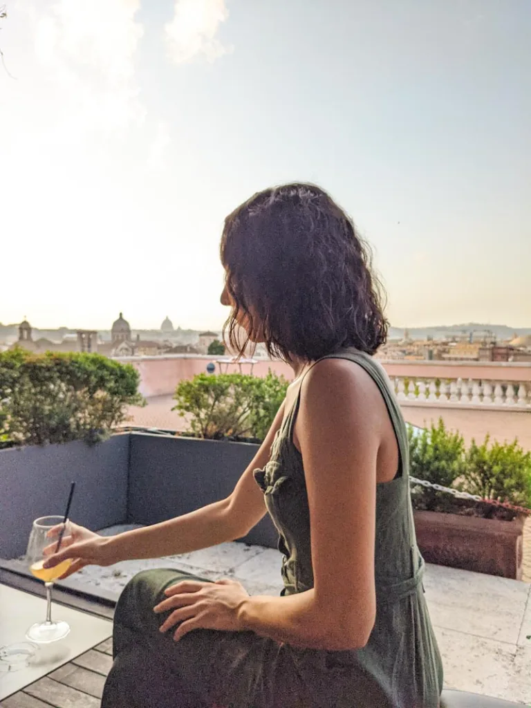 Woman holding at glass of wine at Terrazza Caffarelli in Rome