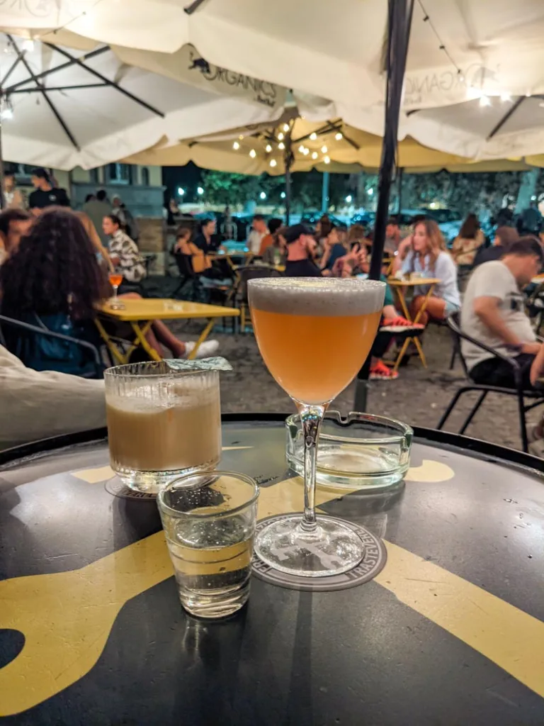 Two cocktail drinks on an outdoor table at Freni e frizioni