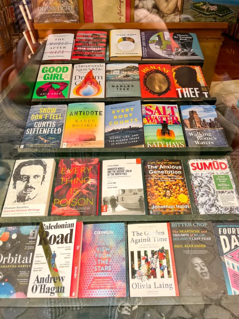 Books displayed on a table in a small bookshop in Trastevere