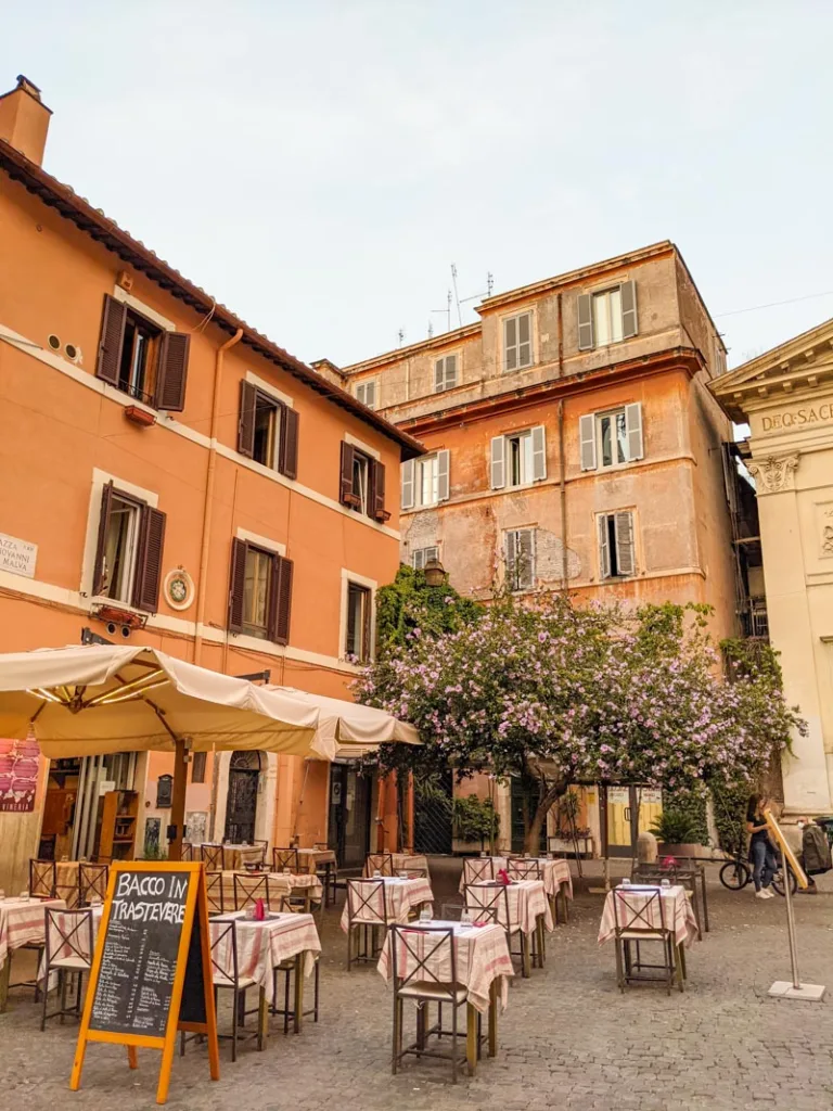 Outdoor dining tables on a cute street in Trastevere, Rome