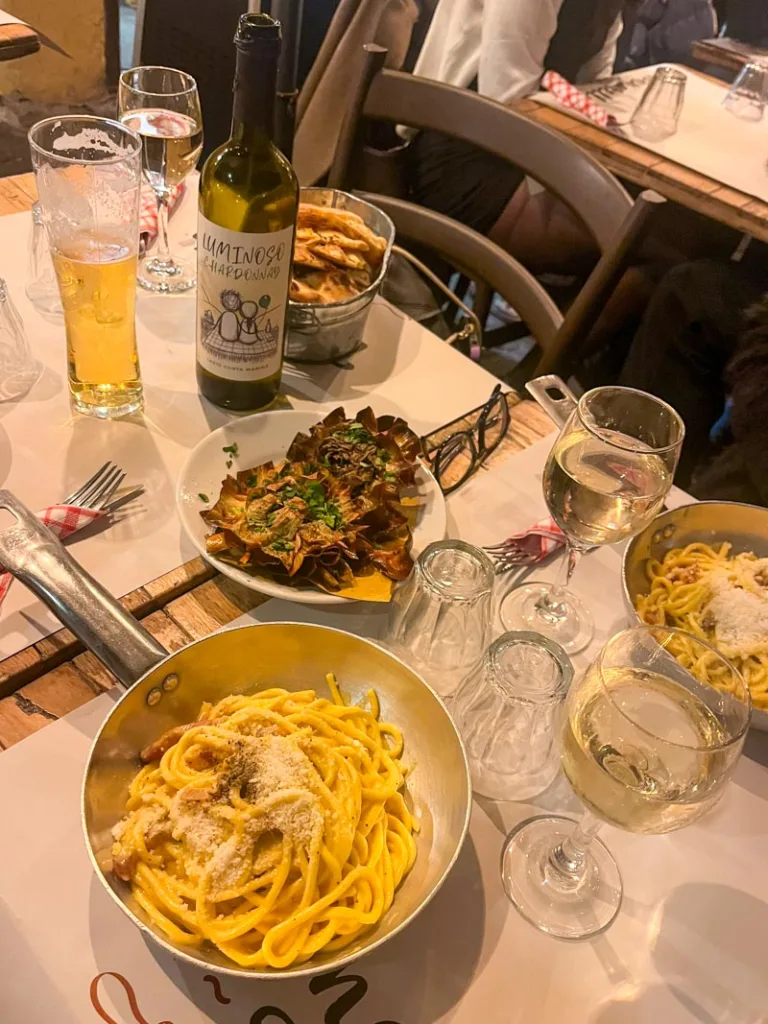 Pasta dishes on a table and Roman artichoke at Tonarello in Trastevere