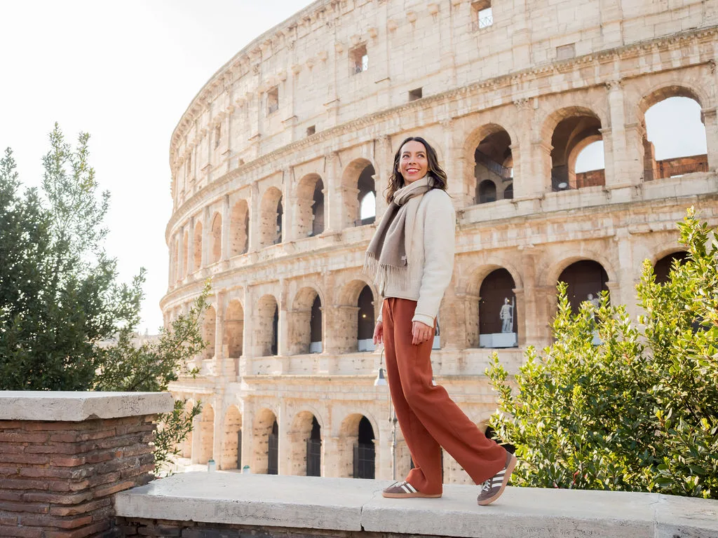 woman standing in front of the colosseum, at a photogenic spot in Monti, Rome