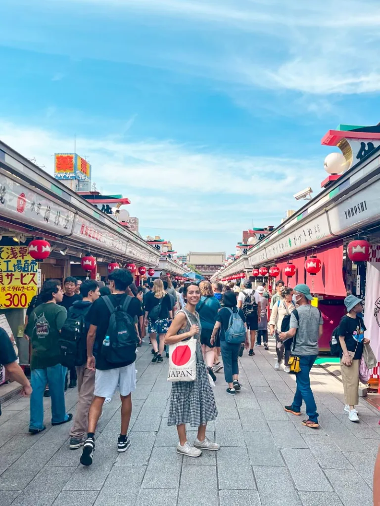 Woman standing in the crowded Nakamise street in Asakusa in Tokyo