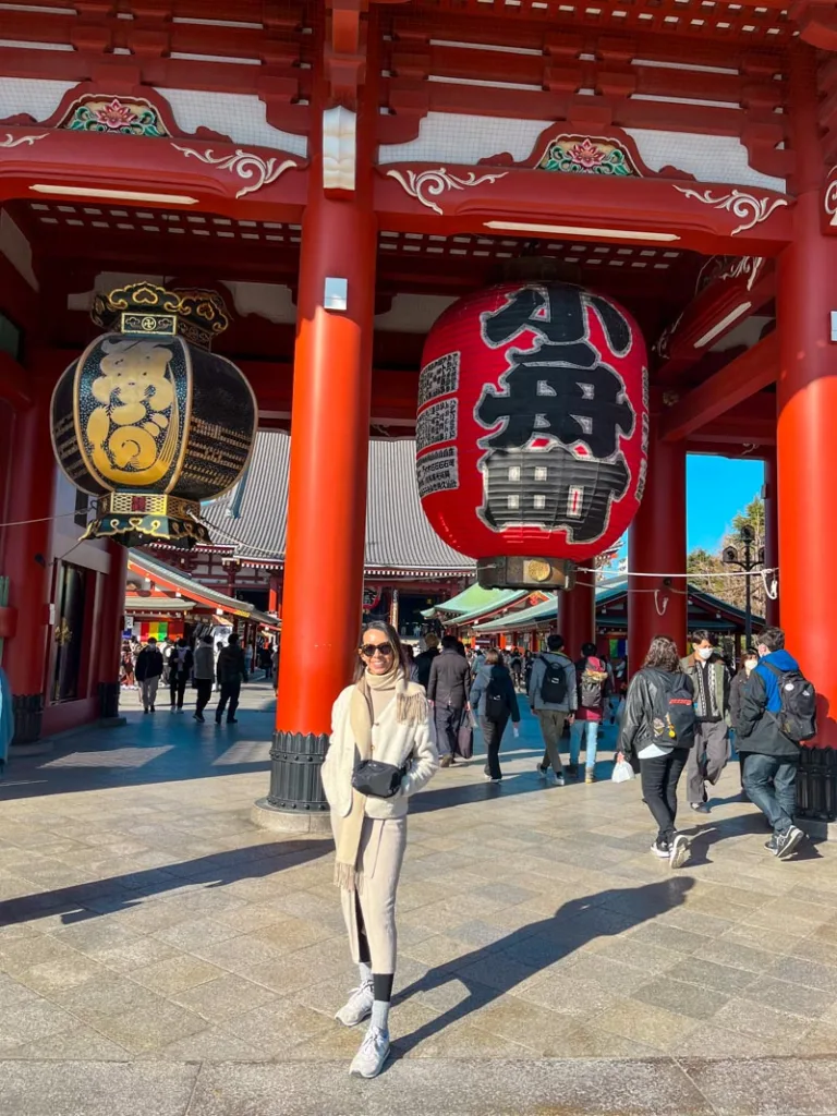 woman standing in front of the Kaminarimon gate in asakusa, tokyo