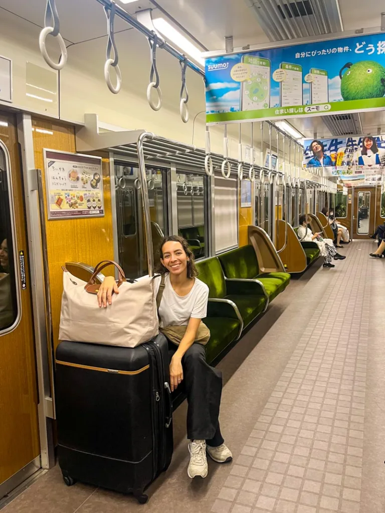 Women with luggage on a Japanese retro looking metro wagon