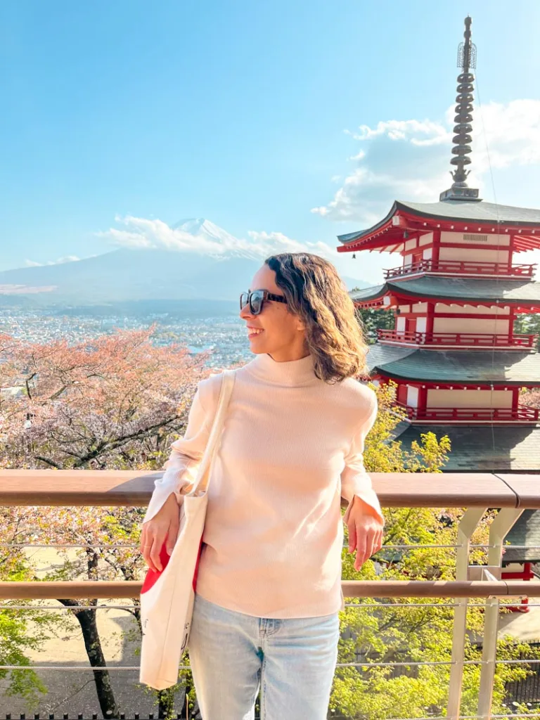 Woman smiling in front of chureito pagoda in japan