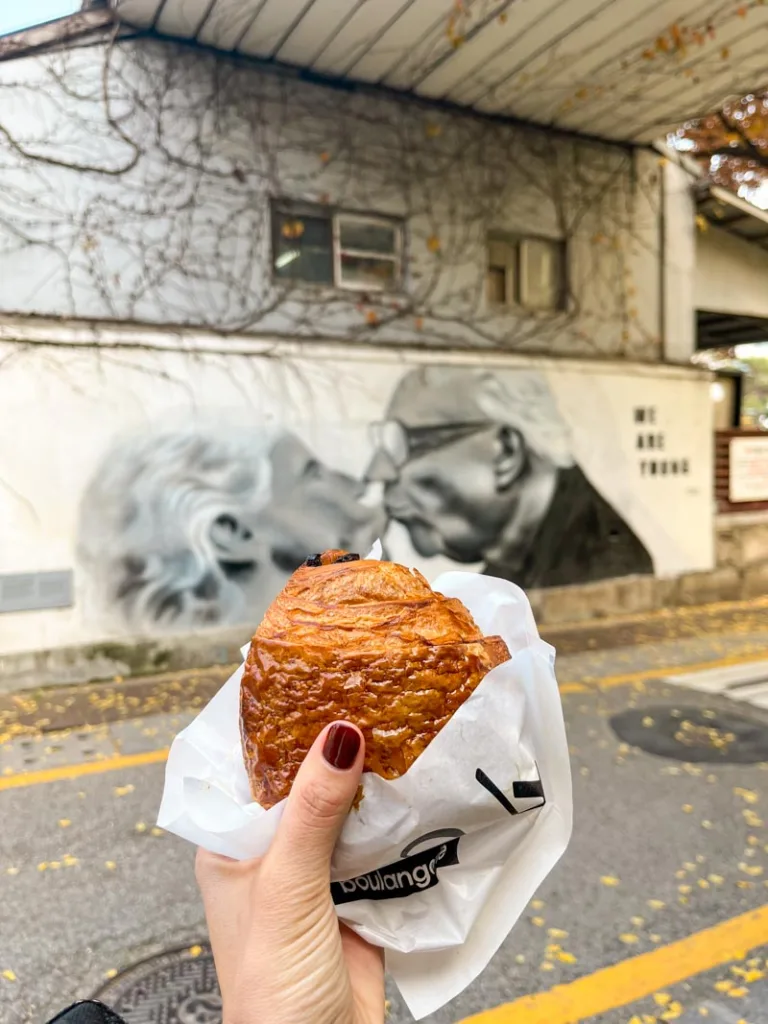 hand holding a pain au chocolat in seoul