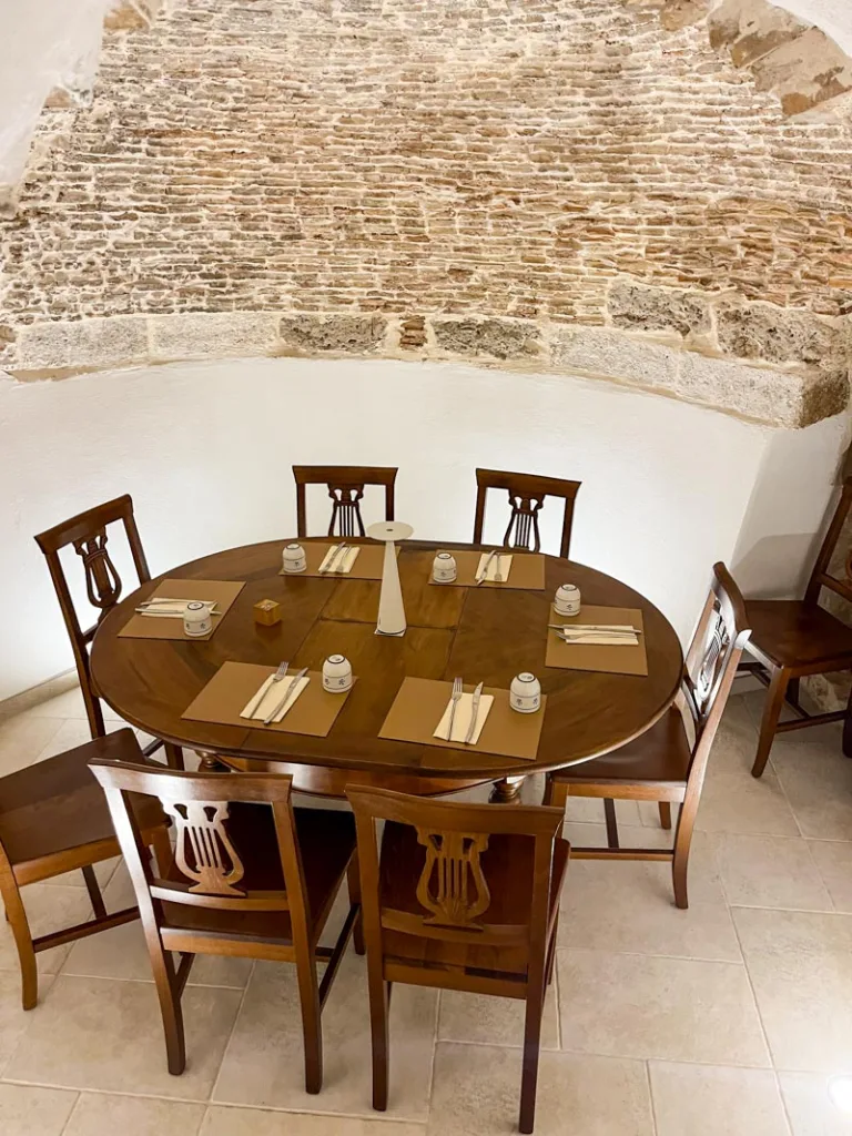 a table at Osteria pizzeria sant'oronzo in ostuni, set inside an old buildling with exposed brick and low roof