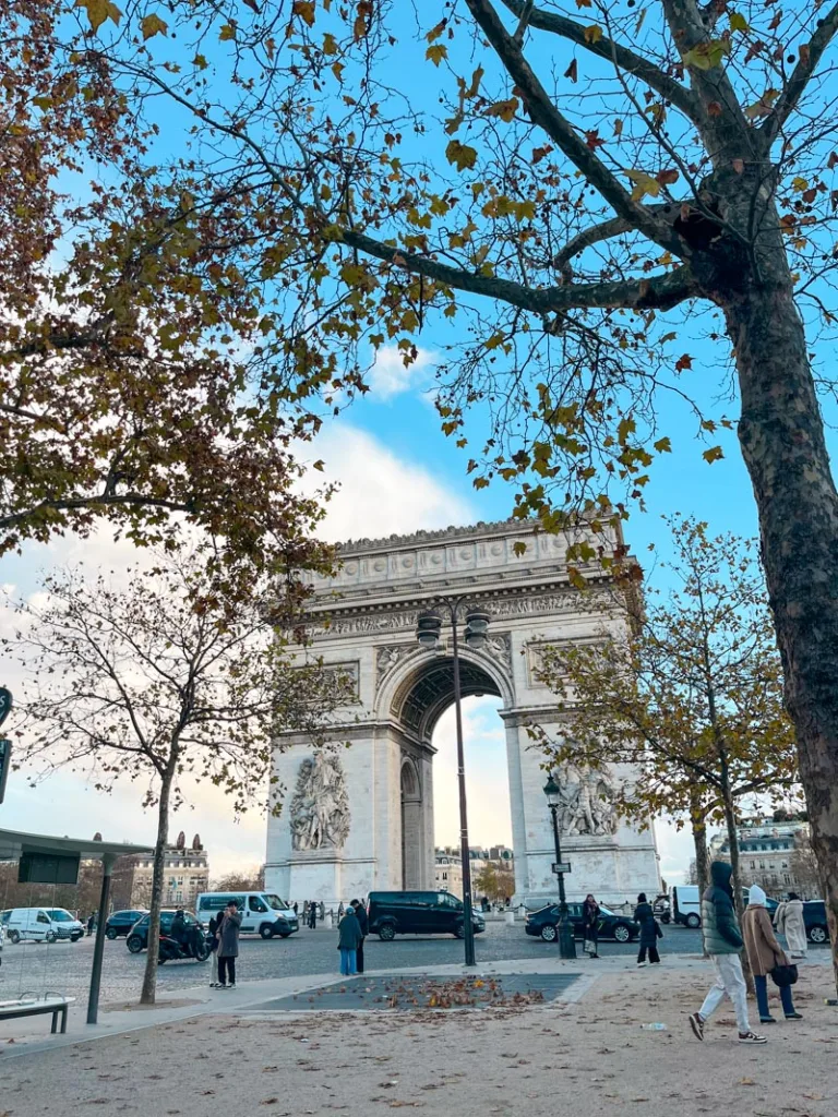 view of the arc de triomphe framed by autumnal trees