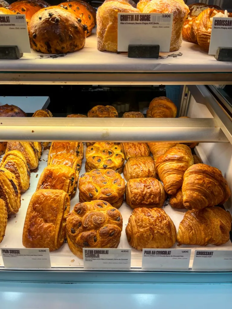 Freshly baked croissants and pastries displayed in a Paris bakery window