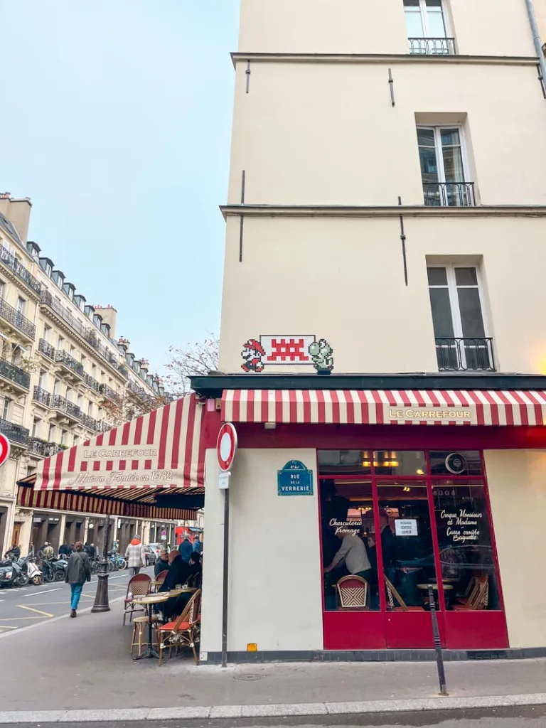 colorful flower shop in le marais with red and white stripes sun cover