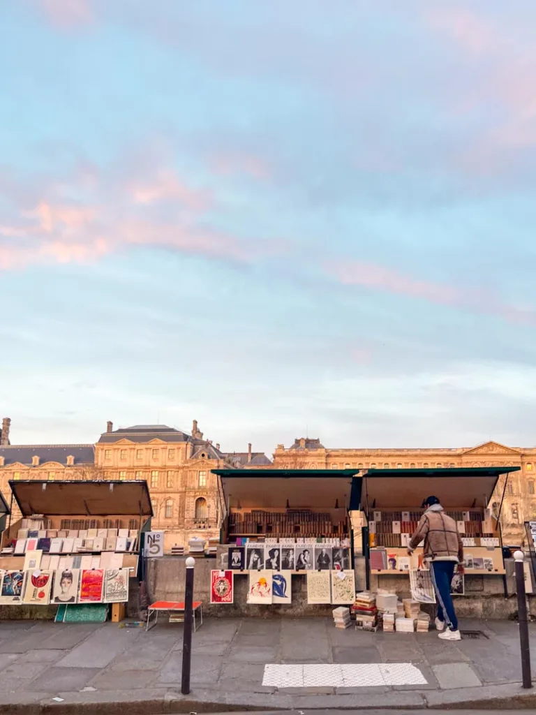 view of bookseller stands along the river seine in paris from across the street
