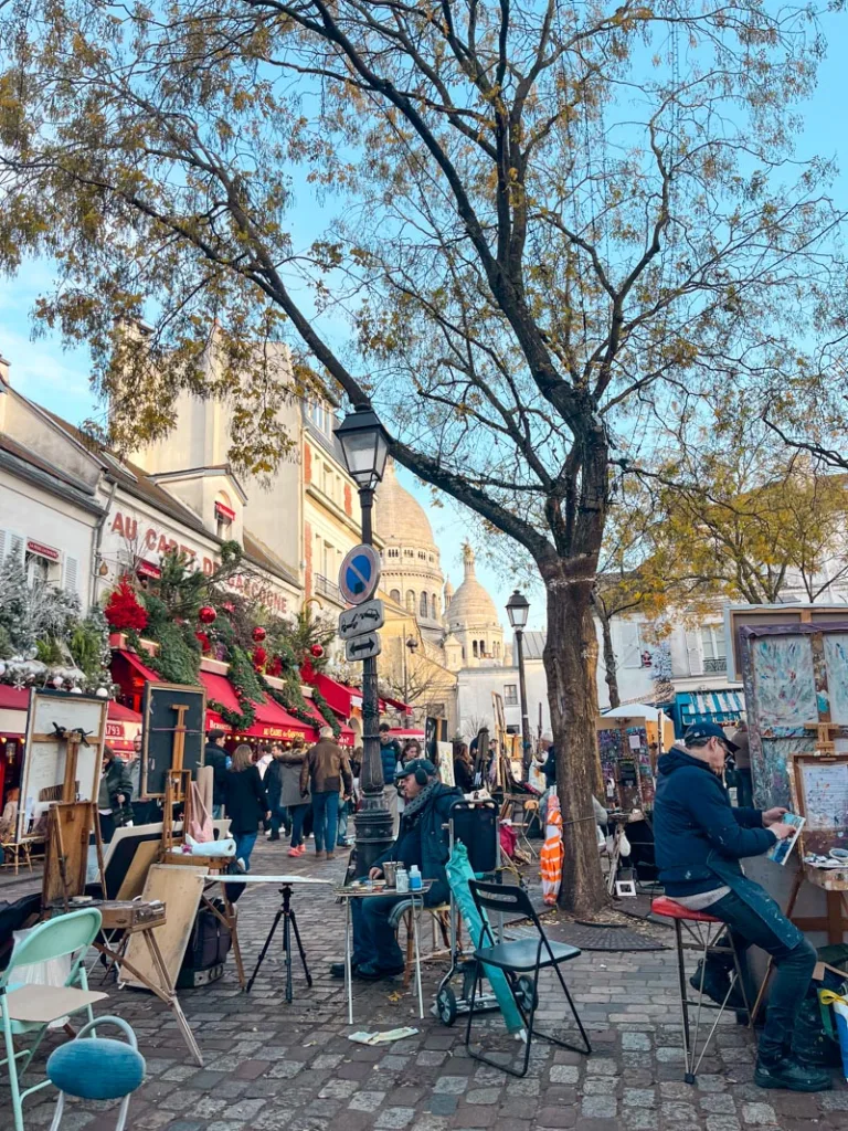 artists at work outdoors at place du tertre, a must-see when spending a day in montmartre