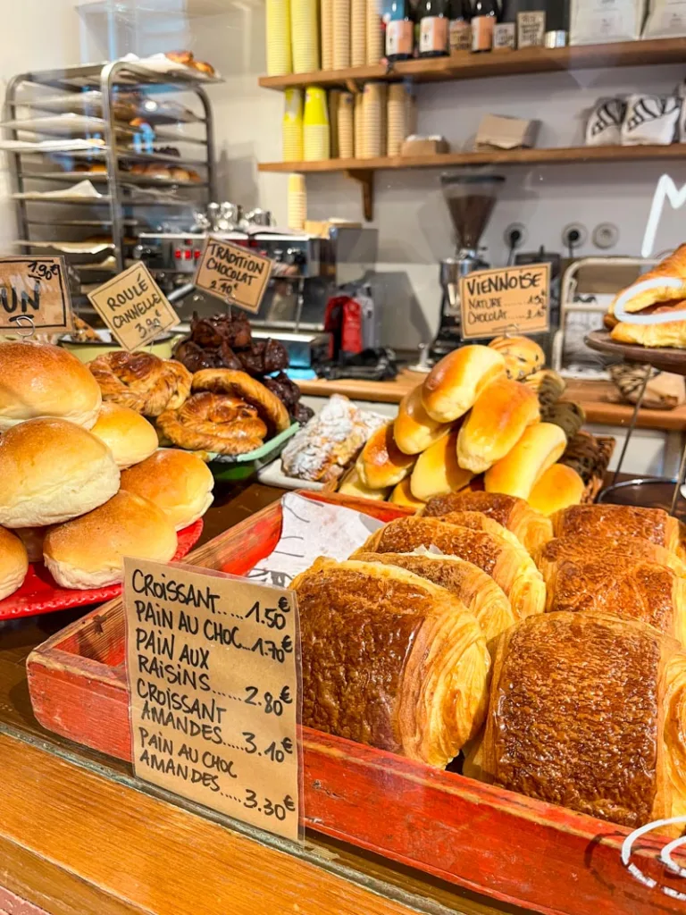 pain au chocolat and other pastries on display at mamiche bakery in paris