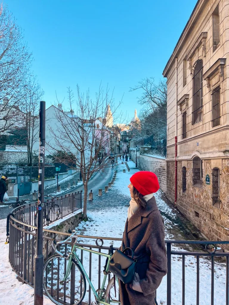 woman standing at the end of rue l'Abrevoir, a must-stop when spending a day in Montmartre, Paris