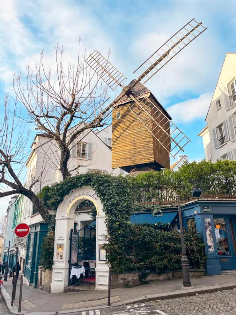 a windmill at le moulin de la galette restaurant in montmartre