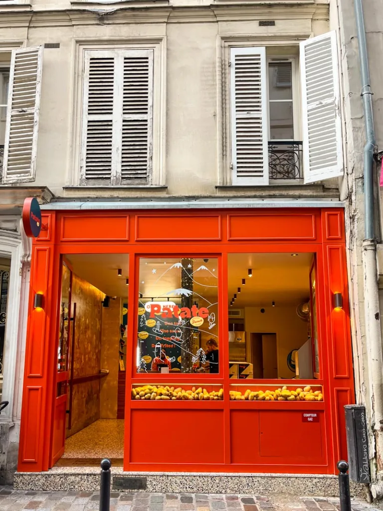 bright red facade of patate french fries shop in paris
