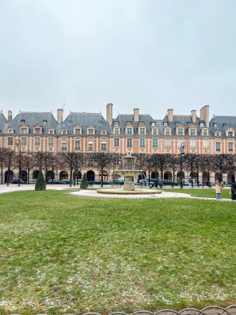 view of the garden at place des vosges in paris