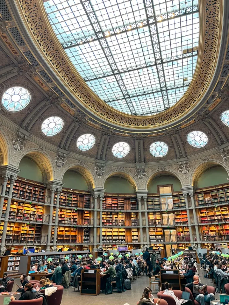 minty green walls and floor to ceiling bookshelves at bibliotheque nationale de france, one of the best things to do in paris when it rains