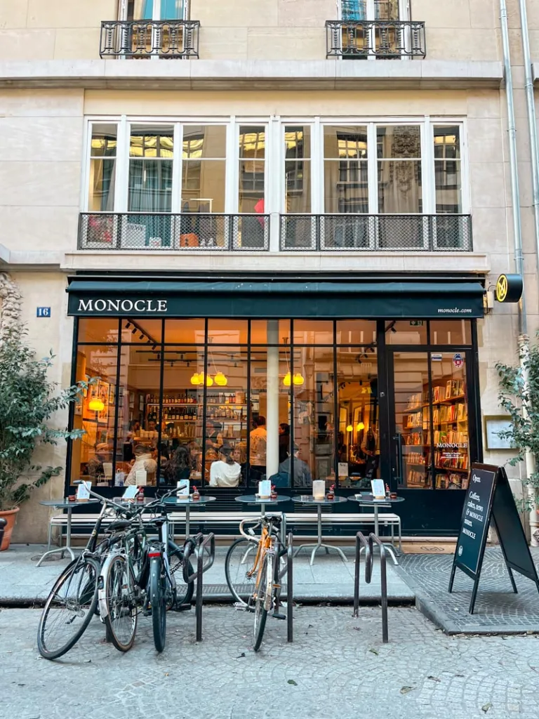 cute facade with big windows at monocle cafe and shop in paris