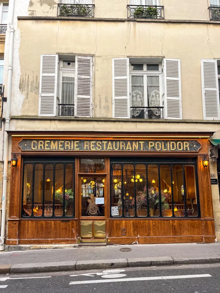 wood paneled facade of polidor restaurant in the latin quarter in paris