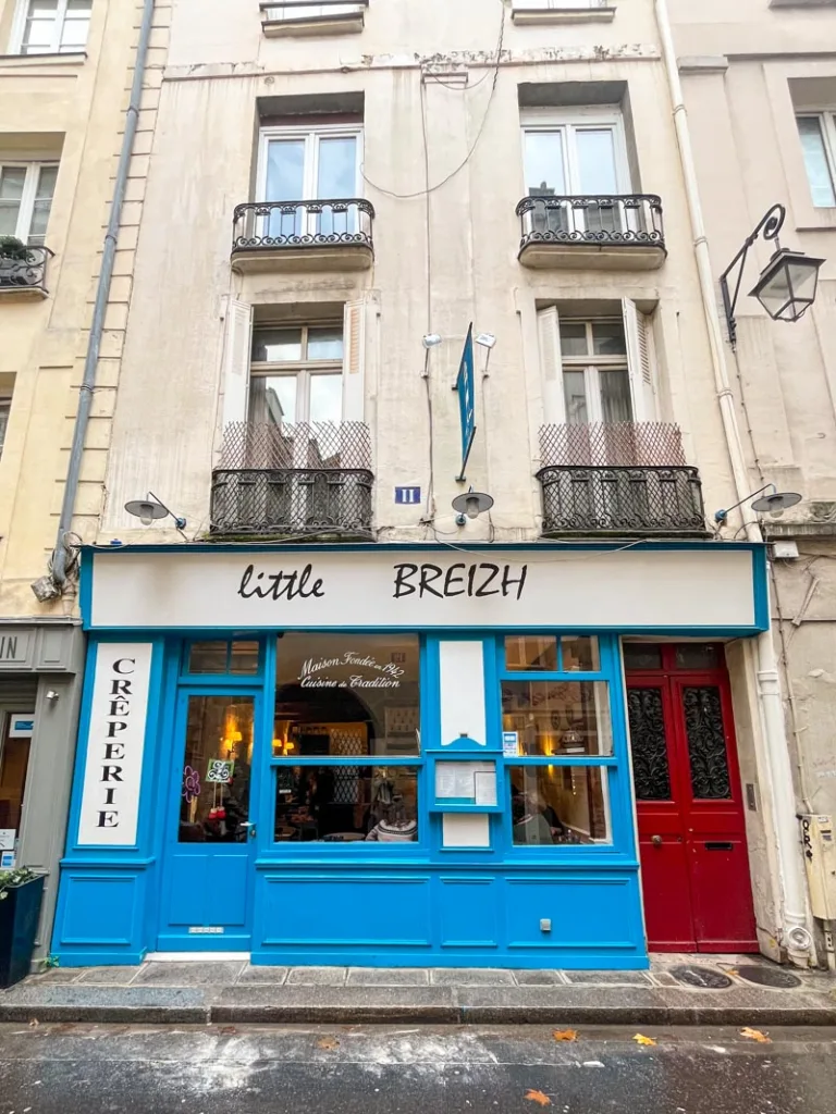 cute blue facade of creperie little breizh in saint germain, paris