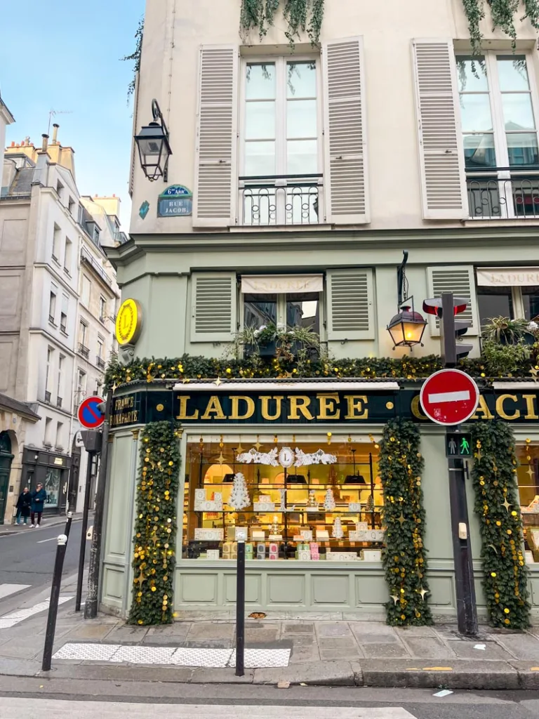 minty green old school facade of laduree shop in saint germain des pres, paris