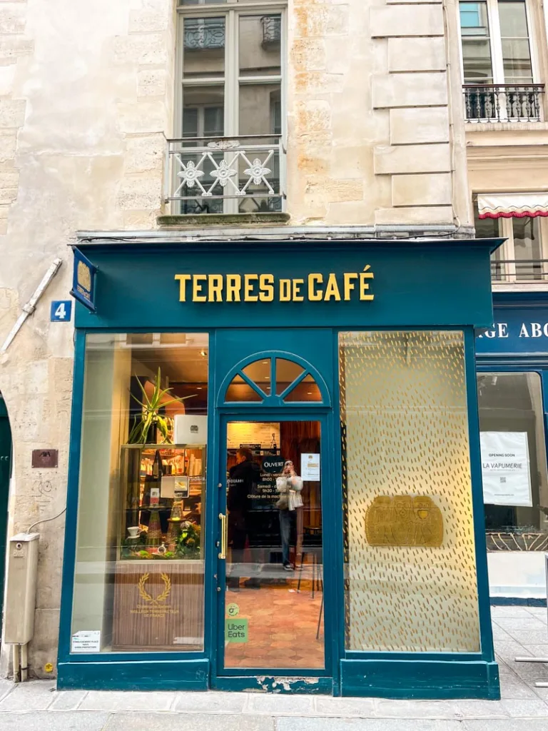 dark blue facade of terres de cafe coffee shop in saint germain des pres, paris