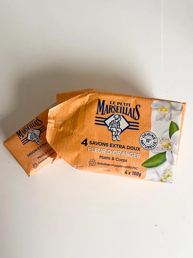 a pack of four le petit marseillais soaps on a white table