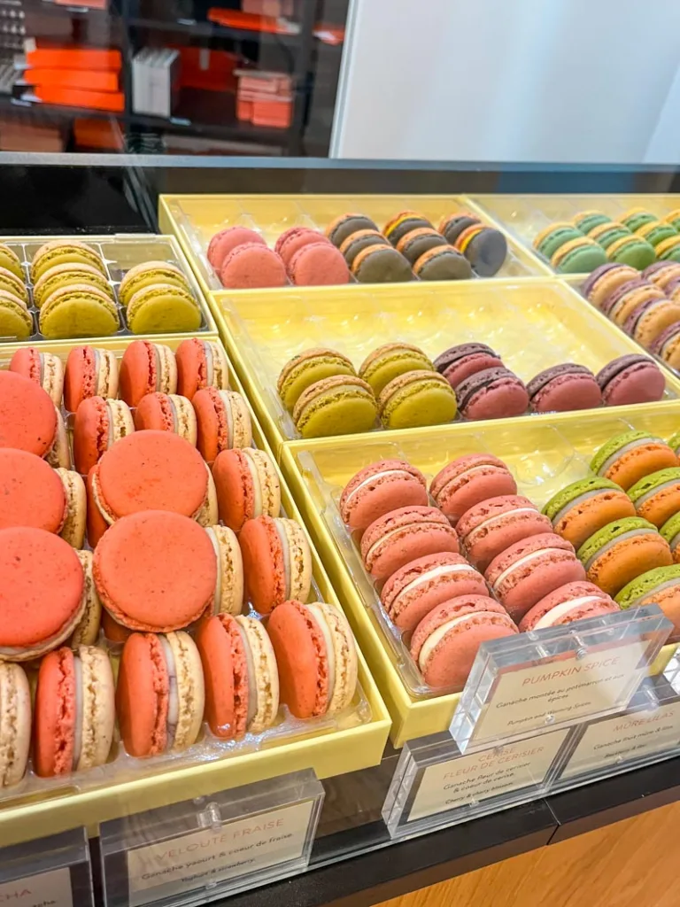 display of colorful macarons at le lautrec in paris