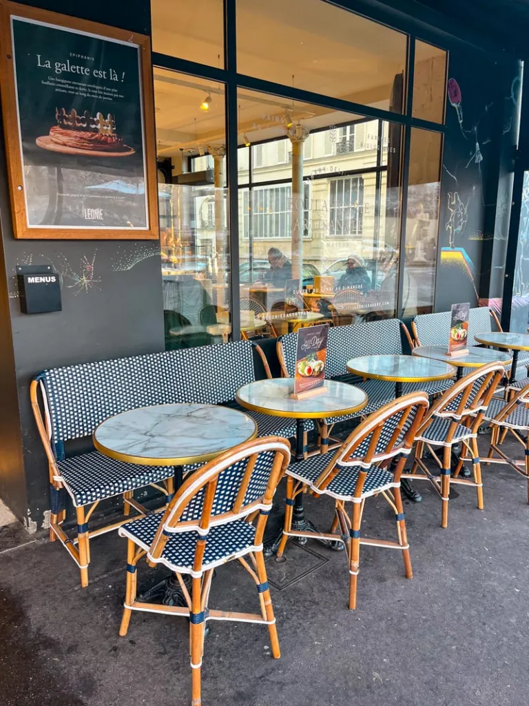 outdoor french cafe tables at leonie bakery in paris