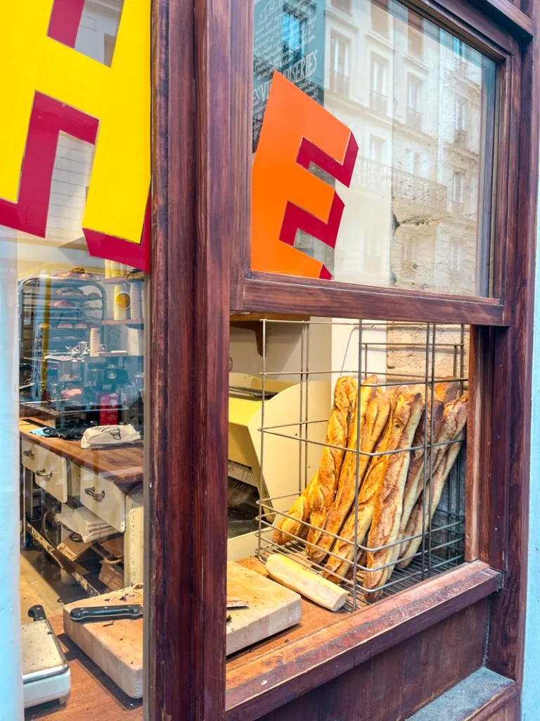 a basket of baguettes on display at a window at mamiche bakery